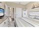 Bright bedroom with a nautical theme, queen bed, and soft lighting, perfect for relaxation at 8309 Ocean Tides Cv, Parrish, FL 34219