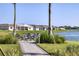 Outdoor fire pit area with comfortable seating, overlooking a scenic lake and surrounding homes at 8309 Ocean Tides Cv, Parrish, FL 34219