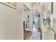 Elegant hallway with wood flooring, leading to the foyer and a glass-paneled office at 8309 Ocean Tides Cv, Parrish, FL 34219