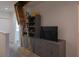 Gray cabinet with TV, bookshelf, and attic ladder access on the second floor at 8521 Canyon Creek Trl, Parrish, FL 34219