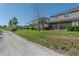 Gravel pathway, lush lawn, and townhouse building with screened patios and well-kept landscaping at 8521 Canyon Creek Trl, Parrish, FL 34219