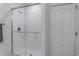 Modern bathroom featuring a glass-enclosed shower and white tile at 8521 Canyon Creek Trl, Parrish, FL 34219