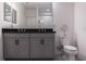 Bathroom featuring double sinks with a black countertop and grey cabinets at 8521 Canyon Creek Trl, Parrish, FL 34219