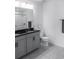 Elegant bathroom with a double sink vanity, granite counters, and stylish tile flooring at 8521 Canyon Creek Trl, Parrish, FL 34219