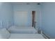 Bedroom with blue walls, featuring two beds and a closet at 8521 Canyon Creek Trl, Parrish, FL 34219