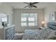 Stylish bedroom bathed in natural light has a ceiling fan and a neutral, serene color scheme at 8521 Canyon Creek Trl, Parrish, FL 34219