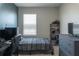Bedroom featuring desk, two beds, dark blue accent wall, and a window at 8521 Canyon Creek Trl, Parrish, FL 34219
