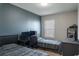 Bedroom with two beds, dark blue accent wall, and a window at 8521 Canyon Creek Trl, Parrish, FL 34219