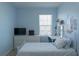 Bedroom featuring a twin bed, white dresser, and light blue walls at 8521 Canyon Creek Trl, Parrish, FL 34219