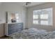 Charming bedroom offers a serene retreat with great natural light and stylish gray and white furnishings at 8521 Canyon Creek Trl, Parrish, FL 34219