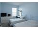Bedroom featuring two twin beds with white metal frames and a light blue wall at 8521 Canyon Creek Trl, Parrish, FL 34219