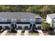 This townhome features a gray roof, gray and blue siding, and a well-manicured front yard at 8521 Canyon Creek Trl, Parrish, FL 34219