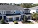 A charming townhome features a gray roof, gray and blue siding, and well-manicured landscaping at 8521 Canyon Creek Trl, Parrish, FL 34219