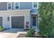 The townhome has light gray siding, a dark gray garage door, and is nicely landscaped at 8521 Canyon Creek Trl, Parrish, FL 34219
