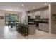 Bright kitchen features a center island with bar stool seating, stainless appliances and backyard dining area at 8521 Canyon Creek Trl, Parrish, FL 34219