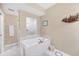 Bathroom featuring a soaking tub, shower, and a neutral color scheme at 9203 Griggs Rd # A302, Englewood, FL 34224