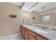 Bathroom featuring double sinks, granite countertop, and neutral color scheme at 9203 Griggs Rd # A302, Englewood, FL 34224