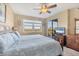 Cozy bedroom with a balcony, ceiling fan, and window that brings in lots of light at 9203 Griggs Rd # A302, Englewood, FL 34224
