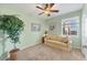 Cozy bedroom with soft green walls, neutral carpet, and bright natural light from the window at 9203 Griggs Rd # A302, Englewood, FL 34224