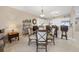 The dining area showcases modern lighting, a dining table and a breakfast bar flowing into the kitchen at 9203 Griggs Rd # A302, Englewood, FL 34224