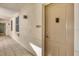 Well-lit hallway with unit number and door, showcasing a clean and inviting entrance at 9203 Griggs Rd # A302, Englewood, FL 34224