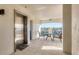 Hallway elevator leading to a screened lanai with seating and waterfront views at 9203 Griggs Rd # A302, Englewood, FL 34224