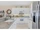 Well-equipped kitchen featuring stainless appliances, granite countertops, white cabinetry and a seamless flow to other spaces at 9203 Griggs Rd # A302, Englewood, FL 34224