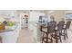 Open concept kitchen boasts sleek countertops, modern appliances, white cabinetry, and a convenient breakfast bar with seating at 9203 Griggs Rd # A302, Englewood, FL 34224
