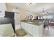 Modern kitchen features sleek appliances, granite countertops, a breakfast bar, and seamless flow into adjacent living spaces at 9203 Griggs Rd # A302, Englewood, FL 34224