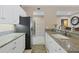 Modern kitchen features sleek appliances, granite countertops, a breakfast bar, and seamless flow into adjacent living spaces at 9203 Griggs Rd # A302, Englewood, FL 34224