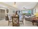 Bright and airy living room featuring a glass table, comfortable seating, and an entertainment center with outdoor views at 9203 Griggs Rd # A302, Englewood, FL 34224