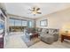 Inviting living room with tile flooring, cozy seating, and a screened lanai offering scenic views at 9203 Griggs Rd # A302, Englewood, FL 34224