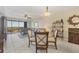 Bright and airy living room featuring a glass table, comfortable seating, and access to an outdoor balcony with stunning views at 9203 Griggs Rd # A302, Englewood, FL 34224
