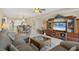 Spacious living area with comfortable seating, a TV, and an open view into the kitchen and dining spaces at 9203 Griggs Rd # A302, Englewood, FL 34224