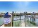 Community boat dock with lifts and slips in a picturesque marina setting at 9203 Griggs Rd # A302, Englewood, FL 34224