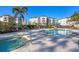 Relaxing pool and hot tub area with plenty of lounge chairs on a sunny day at 9203 Griggs Rd # A302, Englewood, FL 34224
