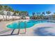Beautiful community pool with palm trees, offering a relaxing oasis for residents at 9203 Griggs Rd # A302, Englewood, FL 34224