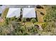 An aerial view of the property showing the roof, landscaping, and proximity to other homes in the neighborhood at 94 Strathmore Blvd, Sarasota, FL 34233
