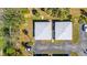 An aerial view of two homes showing their roofs, driveways, landscaping, and the surrounding community layout at 94 Strathmore Blvd, Sarasota, FL 34233