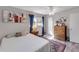 Cozy bedroom with natural light, ceiling fan, warm color palette, and wood-look flooring at 94 Strathmore Blvd, Sarasota, FL 34233