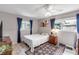 Cozy bedroom featuring a ceiling fan, natural light, neutral walls, and an area rug at 94 Strathmore Blvd, Sarasota, FL 34233