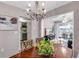 Dining area with chandelier, wood table, and view to the kitchen and living room at 94 Strathmore Blvd, Sarasota, FL 34233