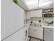 Bright kitchen with white cabinets, stainless steel sink, neutral countertops and modern appliances at 94 Strathmore Blvd, Sarasota, FL 34233