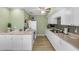 Clean kitchen with white cabinets, modern appliances, and plenty of counter space for meal preparation at 94 Strathmore Blvd, Sarasota, FL 34233