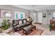 Comfortable living room with natural light, a large couch, and wood-look flooring at 94 Strathmore Blvd, Sarasota, FL 34233