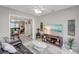 Spacious living room with beach view television, neutral decor and tile flooring throughout at 94 Strathmore Blvd, Sarasota, FL 34233