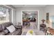 Open living room and dining area with tile and wood flooring, a chandelier, and a view to the backyard at 94 Strathmore Blvd, Sarasota, FL 34233