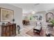 Inviting living room and dining area with wood floors, bright light, and charming decor and furnishings at 94 Strathmore Blvd, Sarasota, FL 34233