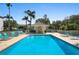 Community pool featuring a sun deck with lounge chairs and well-maintained landscaping at 9580 High Gate Dr # 1822, Sarasota, FL 34238