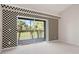 A brightly lit living room with a sliding door leading to an enclosed lanai at 9580 High Gate Dr # 1822, Sarasota, FL 34238